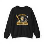 Black crewneck sweatshirt featuring vintage Cynthiana Cobblers baseball team logo with player holding bat and shoe.