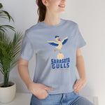 Sarasota Gulls Premium Lightweight T-Shirt in light blue with the cream cartoon gull balancing on a baseball with wings spread on the front, worn by model