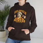 Goldfield Miners Hoodie in dark chocolate with the Goldfield Miners logo, a mustached miner with a candle on his cap and a pickaxe on his shoulder on the front, worn by model