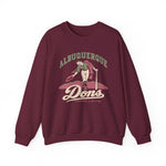 Albuquerque Dons Crewneck Sweatshirt in maroon with the Albuquerque Dons logo, a caped ballplayer bowing with his hat swept off in front of pink mountains, with Dons in cream script on the front