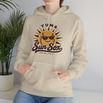 Yuma Sun Sox Hoodie in sand with the Yuma Sun Sox logo, a smiling baseball sun wearing sunglasses on the front, worn by model