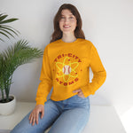 Tri-City Atoms Crewneck Sweatshirt in gold with the Tri-City Atoms logo, a baseball at the center of a yellow atom with orbiting electrons on the front, worn by model