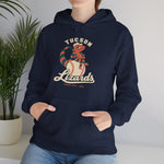 Tucson Lizards Hoodie in navy with the Tucson Lizards logo, a striped lizard in a ball cap lounging on a baseball on the front, worn by model