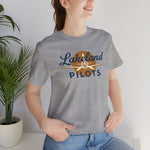Lakeland Pilots Premium Lightweight T-Shirt in athletic heather with the airplane propeller nose art over bold navy block lettering on the front, worn by model