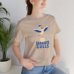 Sarasota Gulls Premium Lightweight T-Shirt in tan with the cream cartoon gull balancing on a baseball with wings spread on the front, worn by model