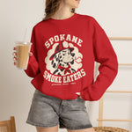 Spokane Smoke Eaters Crewneck Sweatshirt in red with the Spokane Smoke Eaters logo, a Dalmatian in a red fire helmet and bandana blowing smoke on the front, worn by model