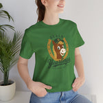 Ocala Yearlings Premium Lightweight T-Shirt in leaf with the horse head peeking through a gold horseshoe wearing a green cap on the front, worn by model