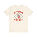 Key West Conchs Premium Lightweight T-Shirt in natural with the grinning striped conch shell mascot inside a teal diamond outline on the front