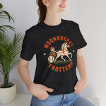 Woonsocket Trotters Premium Lightweight T-Shirt in black with the Woonsocket Trotters logo, a harness racing driver in a baseball cap behind a trotting horse, the sulky wheel drawn as a baseball on the front, worn by model