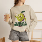 Portland Green Gages Crewneck Sweatshirt in sand with the Portland Green Gages logo, a cartoon green plum tossing a baseball on the front, worn by model
