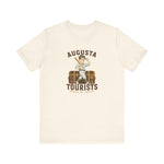 Augusta Tourists Premium Lightweight T-Shirt in natural with the cartoon ballplayer with a bat standing on a travel trunk on the front