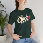 Wenatchee Chiefs Premium Lightweight T-Shirt in forest with the Wenatchee Chiefs logo, script lettering with an apple stitched like a baseball on the front, worn by model