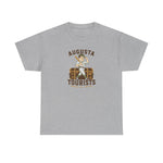 Augusta Tourists Heavyweight T-Shirt in sport grey with the cartoon ballplayer with a bat standing on a travel trunk on the front