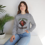Las Cruces Farmers Crewneck Sweatshirt in sport grey with the Las Cruces Farmers logo, a red chile pepper pitcher in a high-kick windup on a brown diamond, with Farmers in brown block letters on the front, worn by model
