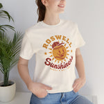 Roswell Sunshiners Premium Lightweight T-Shirt in natural with the Roswell Sunshiners logo, a smiling baseball sun in a red cap, with Sunshiners in red script on the front, worn by model