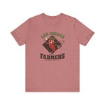 Las Cruces Farmers Premium Lightweight T-Shirt in heather mauve with the Las Cruces Farmers logo, a red chile pepper pitcher in a high-kick windup on a brown diamond, with Farmers in brown block letters on the front