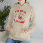 Key West Conchs Hoodie in sand with the grinning striped conch shell mascot inside a teal diamond outline on the front, worn by model