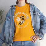 Bisbee Bees Heavyweight T-Shirt in gold with the Bisbee Bees logo, a cartoon bee in a ball cap catching a baseball on the front, worn by model