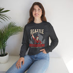 Seattle Drydockers Crewneck Sweatshirt in dark heather with the Seattle Drydockers logo, a shipyard worker raising a bat in front of a ship in drydock on the front, worn by model