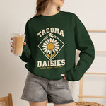Tacoma Daisies Crewneck Sweatshirt in forest green with the Tacoma Daisies logo, a daisy inside a diamond with a mountain peak above on the front, worn by model