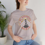 St. Augustine Saints Premium Lightweight T-Shirt in heather cool grey with the black and white striped lighthouse emblem with gold rays on the front, worn by model