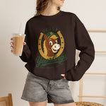 Ocala Yearlings Crewneck Sweatshirt in dark chocolate with the horse head peeking through a gold horseshoe wearing a green cap on the front, worn by model
