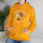 Bisbee Bees Hoodie in gold with the Bisbee Bees logo, a cartoon bee in a ball cap catching a baseball on the front, worn by model