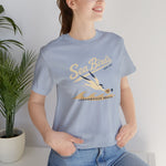 Jacksonville Beach Sea Birds Premium Lightweight T-Shirt in light blue with the diving shorebird skimming over waves in navy script lettering on the front, worn by model
