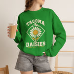 Tacoma Daisies Crewneck Sweatshirt in irish green with the Tacoma Daisies logo, a daisy inside a diamond with a mountain peak above on the front, worn by model