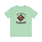 Las Cruces Farmers Premium Lightweight T-Shirt in mint with the Las Cruces Farmers logo, a red chile pepper pitcher in a high-kick windup on a brown diamond, with Farmers in brown block letters on the front