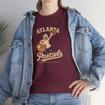 Atlanta Pretzels Heavyweight T-Shirt in maroon with the cream cartoon baker holding a pretzel and basket on the front, worn by model