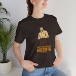 West Palm Beach Sheriffs Premium Lightweight T-Shirt in brown with the cream cartoon sheriff holding two bats on the front, worn by model