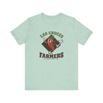 Las Cruces Farmers Premium Lightweight T-Shirt in heather prism mint with the Las Cruces Farmers logo, a red chile pepper pitcher in a high-kick windup on a brown diamond, with Farmers in brown block letters on the front