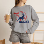 Bend Bucks Crewneck Sweatshirt in sport grey with the Bend Bucks logo, a leaping buck over a red-stitched baseball on the front, worn by model