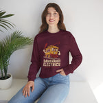 Savannah Electrics Crewneck Sweatshirt in maroon with the yellow cartoon trolley car mascot swinging a bat with sparks on the front, worn by model