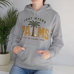 Fort Myers Palms Hoodie in sport grey with the palm tree between bold gold block letters with a baseball on the front, worn by model
