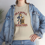 Olympia Senators Heavyweight T-Shirt in sand with the Olympia Senators logo, a bearded senator in a frock coat at a podium with a bat on the front, worn by model