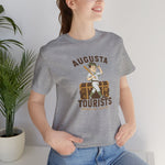 Augusta Tourists Premium Lightweight T-Shirt in athletic heather with the cartoon ballplayer with a bat standing on a travel trunk on the front, worn by model