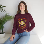 Tri-City Atoms Crewneck Sweatshirt in maroon with the Tri-City Atoms logo, a baseball at the center of a yellow atom with orbiting electrons on the front, worn by model
