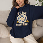York White Roses Hoodie in navy with the York White Roses logo, a cream and blue rose with a baseball at its center on the front, worn by model