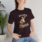 Atlanta Pretzels Premium Lightweight T-Shirt in oxblood black with the cream cartoon baker holding a pretzel and basket on the front, worn by model