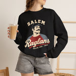 Salem Raglans Crewneck Sweatshirt in black with the Salem Raglans logo, a mustached ballplayer in a raglan shirt on the front, worn by model