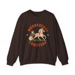 Woonsocket Trotters Crewneck Sweatshirt in dark chocolate with the Woonsocket Trotters logo, a harness racing driver in a baseball cap behind a trotting horse, the sulky wheel drawn as a baseball on the front