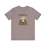 Augusta Tourists Premium Lightweight T-Shirt in pebble brown with the cartoon ballplayer with a bat standing on a travel trunk on the front
