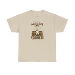 Augusta Tourists Heavyweight T-Shirt in sand with the cartoon ballplayer with a bat standing on a travel trunk on the front