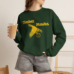 Bend Timber Hawks Crewneck Sweatshirt in forest green with the Bend Timber Hawks logo, a diving gold hawk clutching a baseball on the front, worn by model
