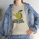 Portland Green Gages Heavyweight T-Shirt in sand with the Portland Green Gages logo, a cartoon green plum tossing a baseball on the front, worn by model
