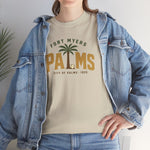 Fort Myers Palms Heavyweight T-Shirt in sand with the palm tree between bold gold block letters with a baseball on the front, worn by model