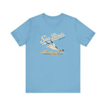 Jacksonville Beach Sea Birds Premium Lightweight T-Shirt in ocean blue with the diving shorebird skimming over waves in navy script lettering on the front
