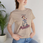 Tonopah Mollycoddles Premium Lightweight T-Shirt in tan with the Tonopah Mollycoddles logo, a monocled deadball-era dandy holding a teacup and leaning on his bat on the front, worn by model